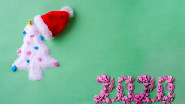 istock Christmas tree Santa hat. Santa's Claus at home at night making magic 1195669483