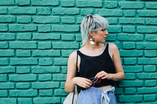 istock Cool girl posing against a wall 1195670895