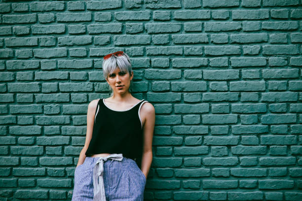 istock Cool girl posing against a wall 1195671753
