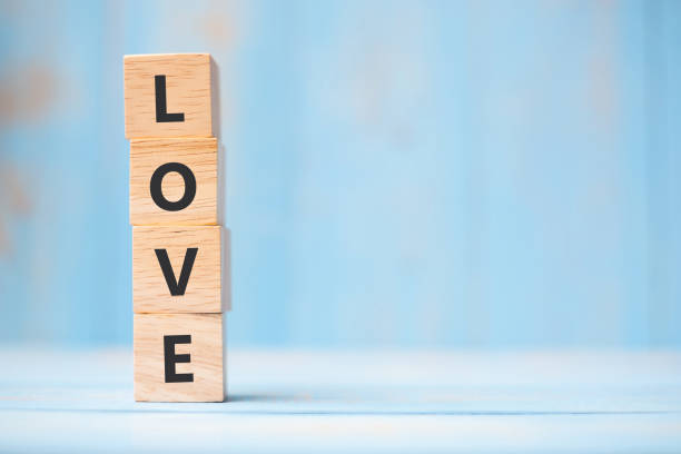 istock LOVE wooden cubes on blue table background with copy space for text. Wedding, Romantic and Happy Valentine
