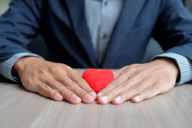 istock Businessman hand holding Red heart 1195674801