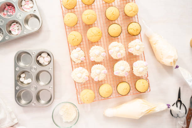 istock Decorating vanilla cupcakes with a white buttercream icing 1195674803