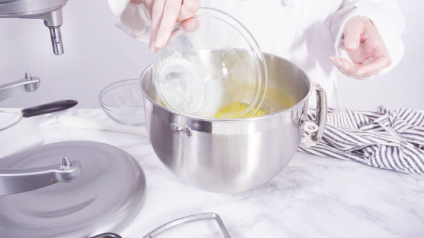 istock Mixing ingredients together into a metal mixing bowl 1195675006