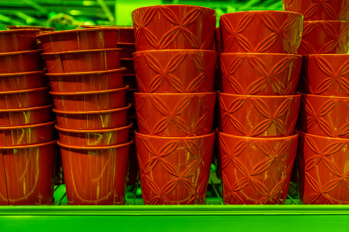Red ceramic containers on shelves