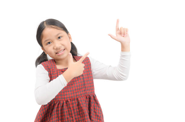 istock Asian cute girl pointing at empty space isolated on white. 1195678248