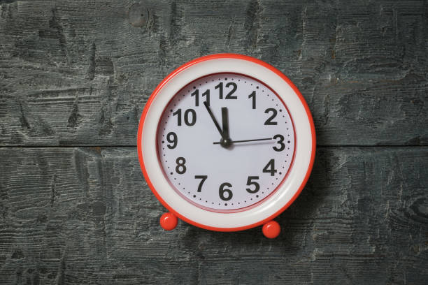 istock Bright red alarm clock on wooden background. 1195678832