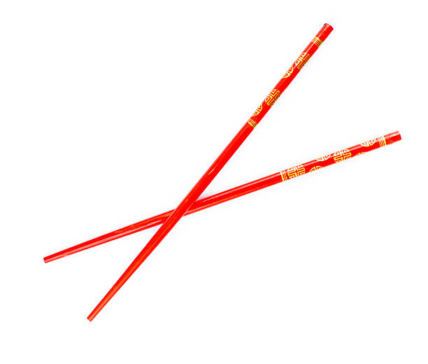 istock Pair of red chopsticks isolated on white background 119567914
