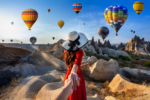 Colorful hot air balloon flying above the clouds