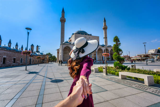 Women tourists holding man's hand and leading him to mosque in Konya, Turkey. Women tourists holding man's hand and leading him to mosque in Konya, Turkey. konya stock pictures, royalty-free photos & images