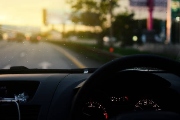 istock Man driving car from rear view on the highway With sunlight. 1195684123