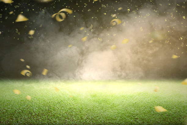 зеленая трава с дымом и летающими золотыми конфетти - indonesia football стоковые фото и изображения