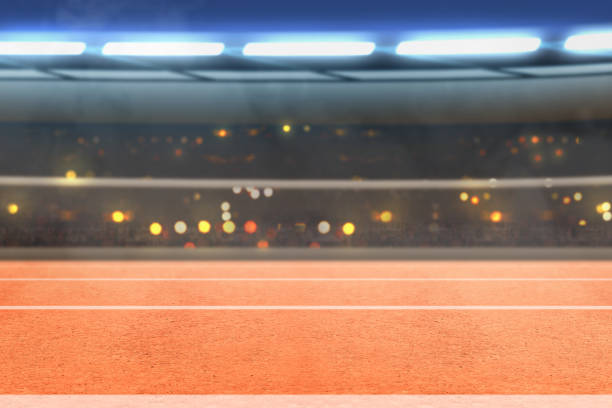 istock Running track and tribune with blurred lights 1195685581