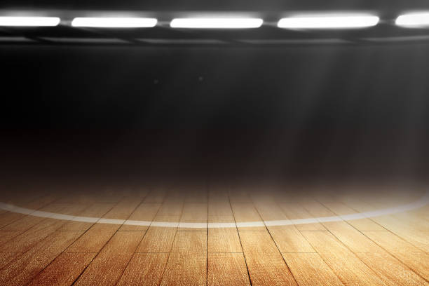Close up view of a basketball court with wooden floor and spotlights Close up view of a basketball court with wooden floor and spotlights over dark background sports court photos stock pictures, royalty-free photos & images
