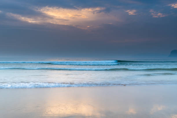 istock Hazy Sunrise Seascape and Clouds 1195685923