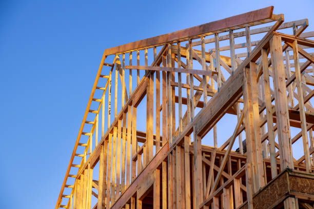 new construction home residential construction home framing against a blue sky - construction frame construction frame house imagens e fotografias de stock