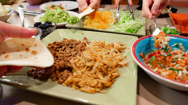 istock Group of people eating taco dinner 1195687759