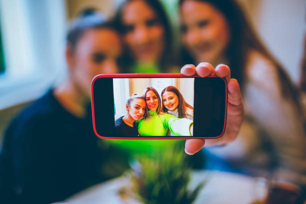istock Three young women making selfie in a cafe 1195688378