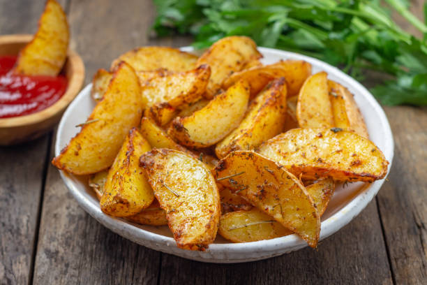 istock Baked potato with spices, herbs and ketchup. 1195688686