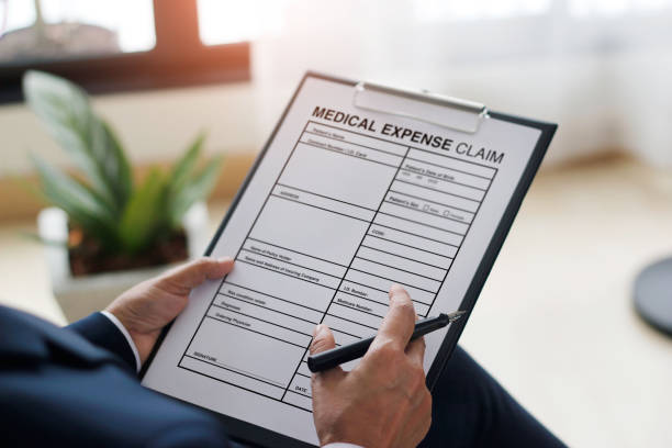 istock Businessman checking document and completing a insurance medical claim form at office work, insurance protection concept 1195691954