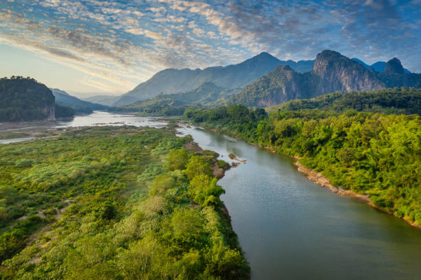 Mekong River in Laos Luang Prabang Pak Ou Drone View Aerial Drone Point of view of the beautiful Mekong River under beautiful twilight skyscape floating between the rolling landscape between the city Luang Prabang and Pak Ou, Mekong River, Luang Prabang, Laos, Southeast Asia laos photos stock pictures, royalty-free photos & images