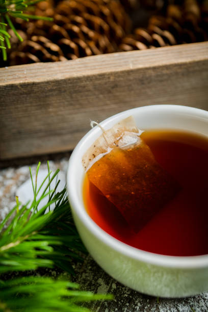 Cup of tea with forest decorations Cup of tea with forest decorations. Selective focus. Shallow depth of field. pine needle tea stock pictures, royalty-free photos & images