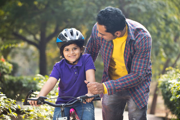 istock Father teaching his son cycling at park 1195692748