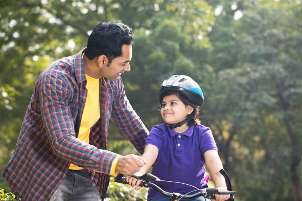 istock Father teaching his son cycling at park 1195695353