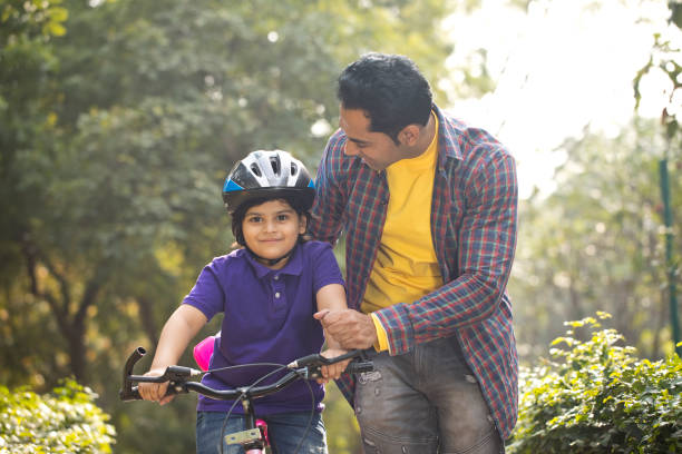 istock Father teaching his son cycling at park 1195695992