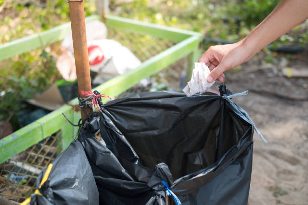 istock Close up hand throwing empty Paper into the trash Recycling Concept 1195696972