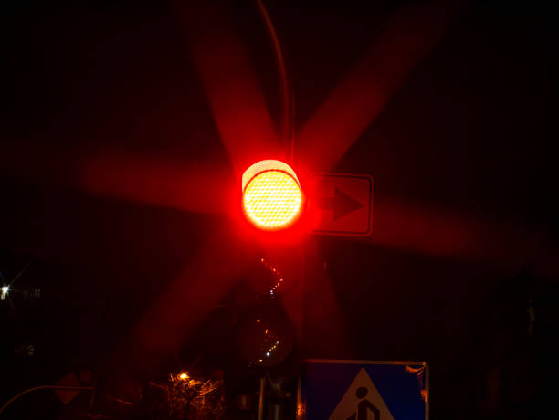 istock Red traffic light for cars at night. 1195701469