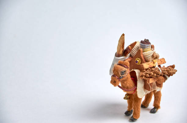 istock Toy camel with a load on the humps close-up on a light background. 1195701613