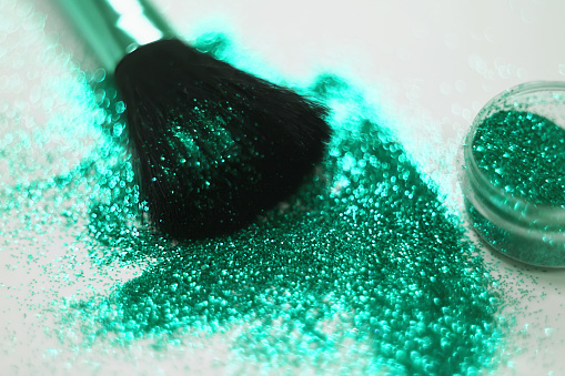 texture of gold glitter on the makeup brush and design. On white background. Selective Focus - Image