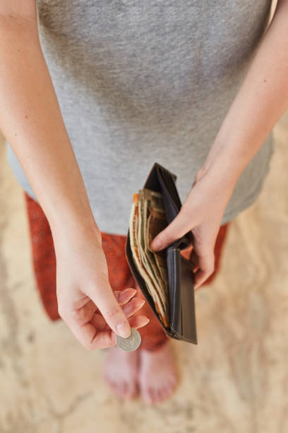 istock A young girl pays Indian rupees. 1195704964