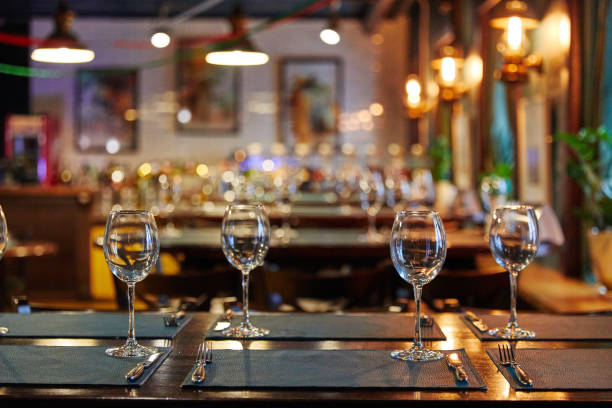 istock empty glass goblets glasses on a wooden table, next to forks 1195710080