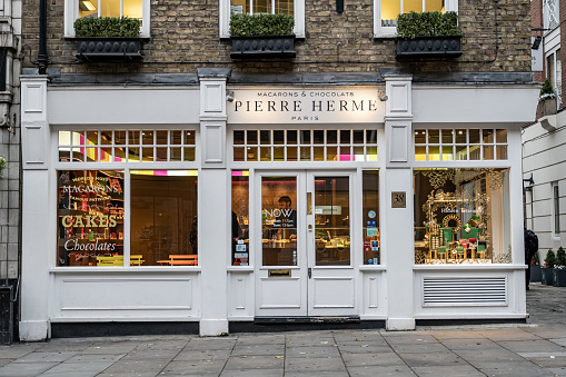 London / UK - Nov 28, 2019: Pierre HermÃ© Macarons and Chocolats shop on Monmouth Street near Seven Dials, Covent Garden, London. Pierre HermÃ© is a French pastry chef and chocolatier