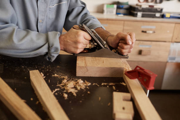 istock Worker grinding the wooden plank 1195719427