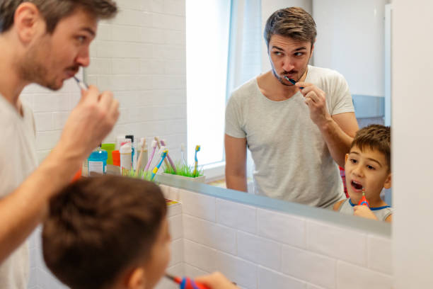 istock Brushing teeth together with his father 1195720580