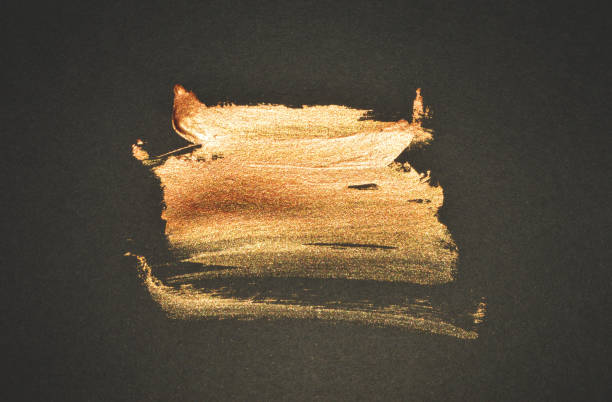 istock Abstract golden watercolor stain on black background 1195722599