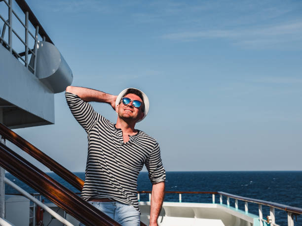 istock Smiling man on the empty deck of a liner 1195722615