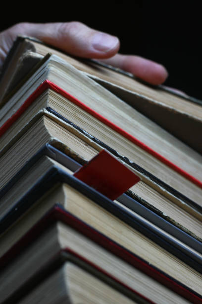 istock hand touching the books on the shelves 1195723841