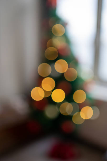 istock Woman decorating christmas tree defocus 1195725894
