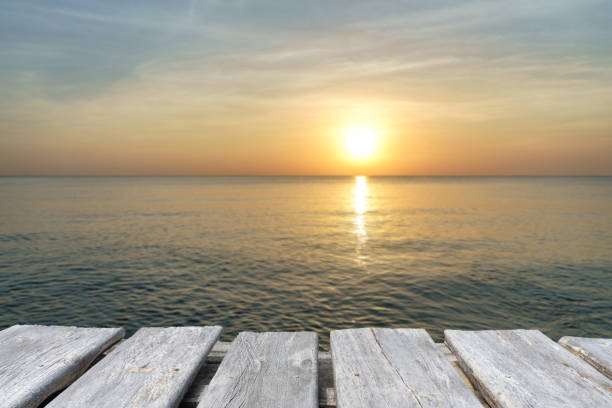 istock empty wooden table on the blurred background of the beach 1195726282