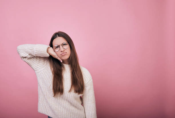 istock Attractive girl in knitted sweater with strange expression on her face 1195726349