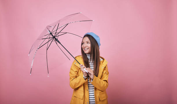 istock Joyful cheerful lady with umbrella looking up and smiling 1195728081