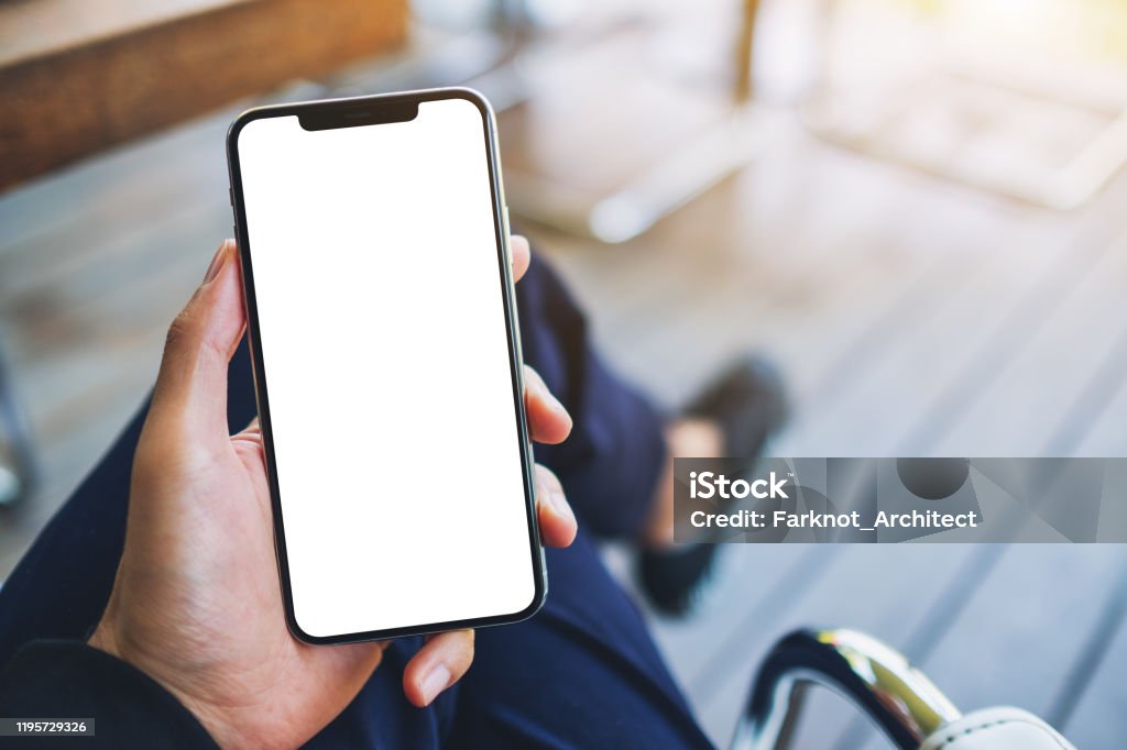 a man holding black mobile phone with blank white screen Mockup image of a man holding black mobile phone with blank white screen Telephone Stock Photo