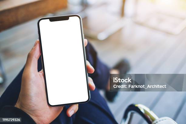 A Man Holding Black Mobile Phone With Blank White Screen Stock Photo - Download Image Now