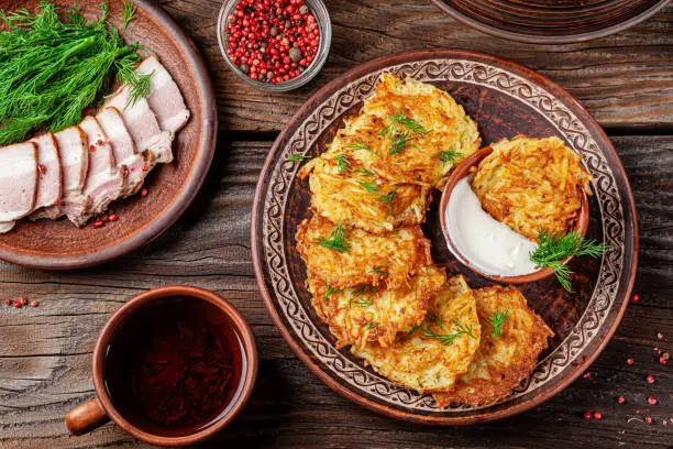 Ukrainian food. A grated potato dish of Deruny or Draniki grated on a clay plate. Serving dishes in a restaurant. Copy space, background image