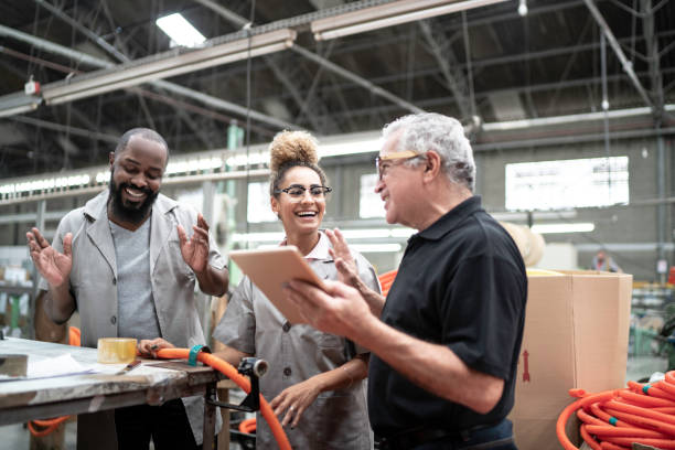 istock Team celebrating in a factory 1195730416