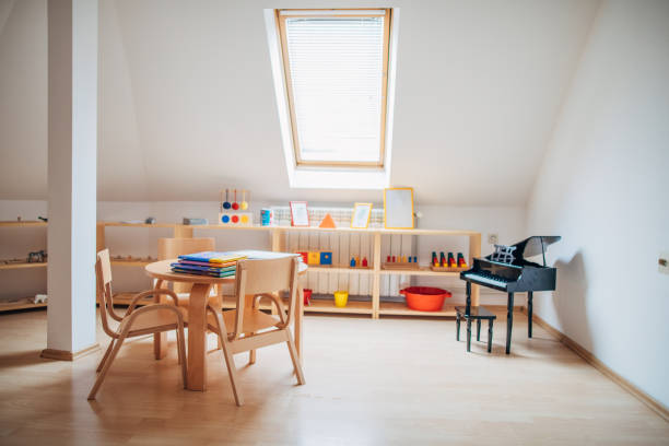 istock Tables and chairs in empty preschool classroom 1195735716