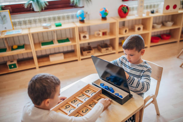 istock Two little boys playing together in preschool classroom 1195736080